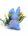 Genähter Upcycling-Hase aus Edelweiss Stoff mit Mini Narzissen im Hintergrund